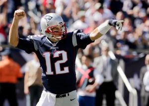 New England Patriots quarterback Tom Brady celebrates a touchdown run by running back Dion Lewis in the first half of an NFL football game Jacksonville Jaguars , Sunday, Sept. 27, 2015, in Foxborough, Mass. (AP Photo/Charles Krupa)