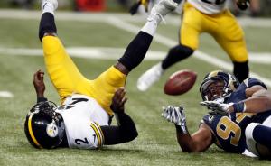 Pittsburgh Steelers quarterback Michael Vick, left, loses the ball as he is hit by St. Louis Rams defensive end Robert Quinn during the fourth quarter of an NFL football game Sunday, Sept. 27, 2015, in St. Louis. The Steelers recovered the fumble. (AP Photo/Tom Gannam)