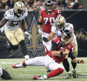 New Orleans Saints outside linebacker Kasim Edebali (91) hits Atlanta Falcons quarterback Matt Ryan (2) during the first half of an NFL football game, Thursday, Oct. 15, 2015, in New Orleans. (AP Photo/John Bazemore)