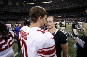 New Orleans Saints quarterback Drew Brees (9) trees New York Giants quarterback Eli Manning (10) after their NFL football game in New Orleans, Sunday, Nov. 1, 2015. The Saints won 52-49. (AP Photo/Butch Dill)