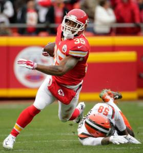 Kansas City Chiefs running back Charcandrick West (35) runs past Cleveland Browns linebacker Chris Kirksey (58) during the first half of an NFL football game in Kansas City, Mo., Sunday, Dec. 27, 2015. (AP Photo/Charlie Riedel)