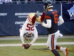San Francisco 49ers strong safety Jimmie Ward (25) dives to the end zone for a touchdown after intercepting a pass as Chicago Bears quarterback Jay Cutler (6) watches during the first half of an NFL football game, Sunday, Dec. 6, 2015, in Chicago. (AP Photo/Charles Rex Arbogast)