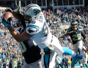 Carolina Panthers tight end Greg Olsen (88) makes a touchdown catch against Seattle Seahawks cornerback Jeremy Lane (20) during the first half of an NFL divisional playoff football game, Sunday, Jan. 17, 2016, in Charlotte, N.C. (AP Photo/Mike McCarn)
