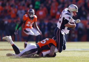 Denver Broncos defensive end Derek Wolfe (95) sacks New England Patriots quarterback Tom Brady during the first half the NFL football AFC Championship game between the Denver Broncos and the New England Patriots, Sunday, Jan. 24, 2016, in Denver. (AP Photo/David Zalubowski)